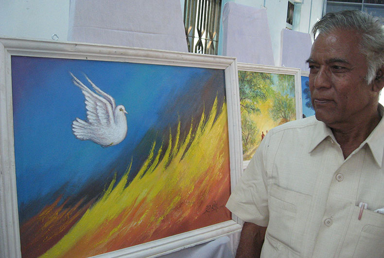Rasheed Artist with his paintings